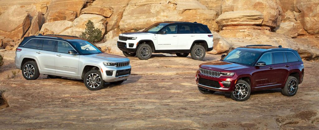 Luxury Jeep Grand Cherokee SUVs displayed in desert setting, highlighting off-road performance, premium styling, and adventure capability