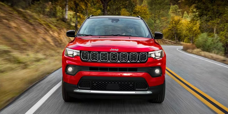 Red Jeep Compass in motion on the road