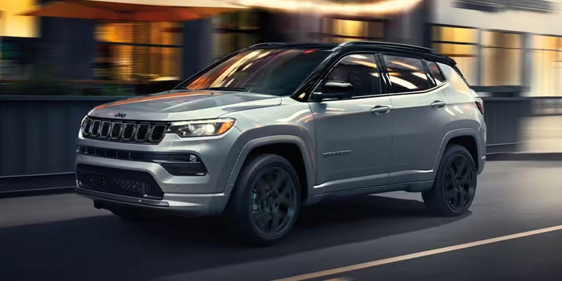 Grey Jeep Compass moving along the road