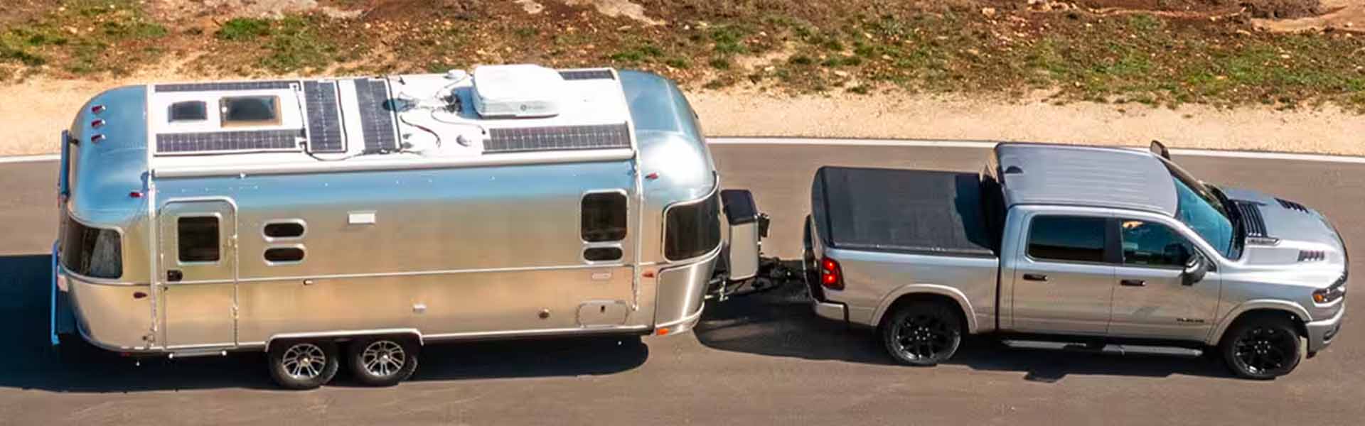 RAM 1500 truck towing a large container on its trailer.